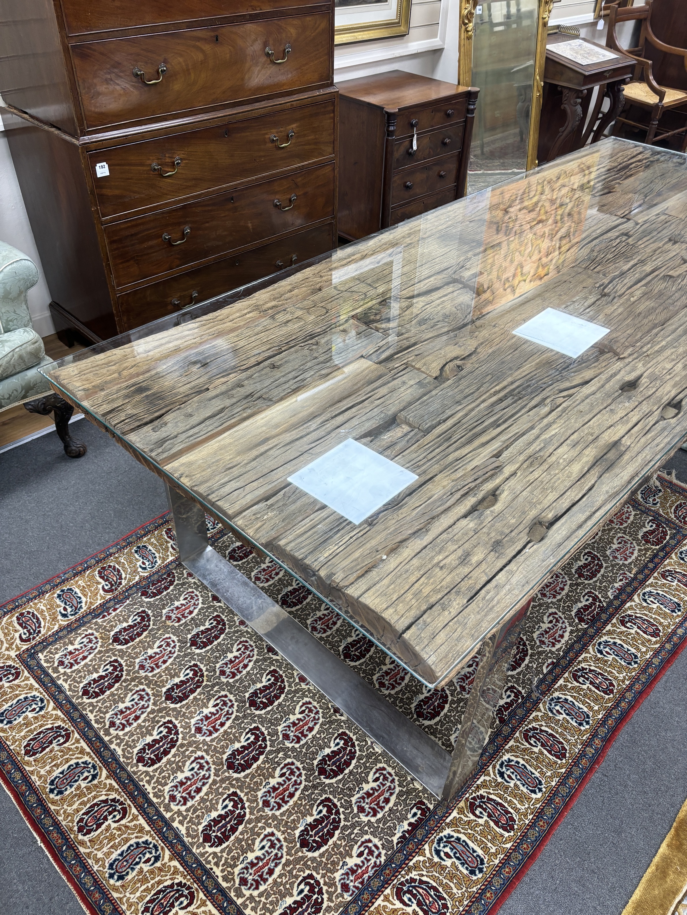 A rustic rectangular driftwood dining table, on a stainless steel base with plate glass top, length 240cm, width 100cm, height 77cm